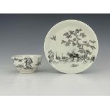 A Worcester monochrome painted tea bowl and saucer