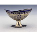 A George III silver sugar basket, London 1787, pierced boat form with beaded swing handle, on oval