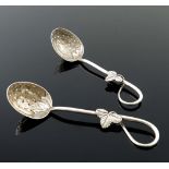 A white metal casting spoon with strawberry moulded reticulated bowl