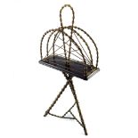 An Aesthetic Movement magazine rack, circa 1880, bamboo simulated brass frame with loop handle and