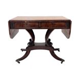 A Regency flame mahogany sofa table, circa 1820, satinwood crossbanded top with end flaps, twin