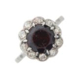A mid 20th century garnet and diamond cluster ring