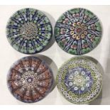 Four Perthshire millefiori and floral cane paperweights, radiating design with latticino rods and