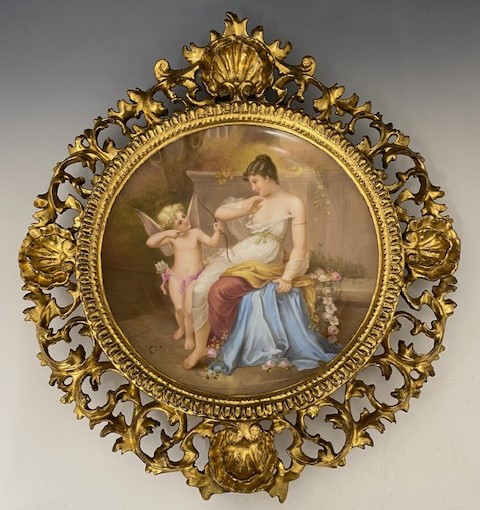 A 19th Century Vienna porcelain concave plaque, painted with a classically draped maiden and