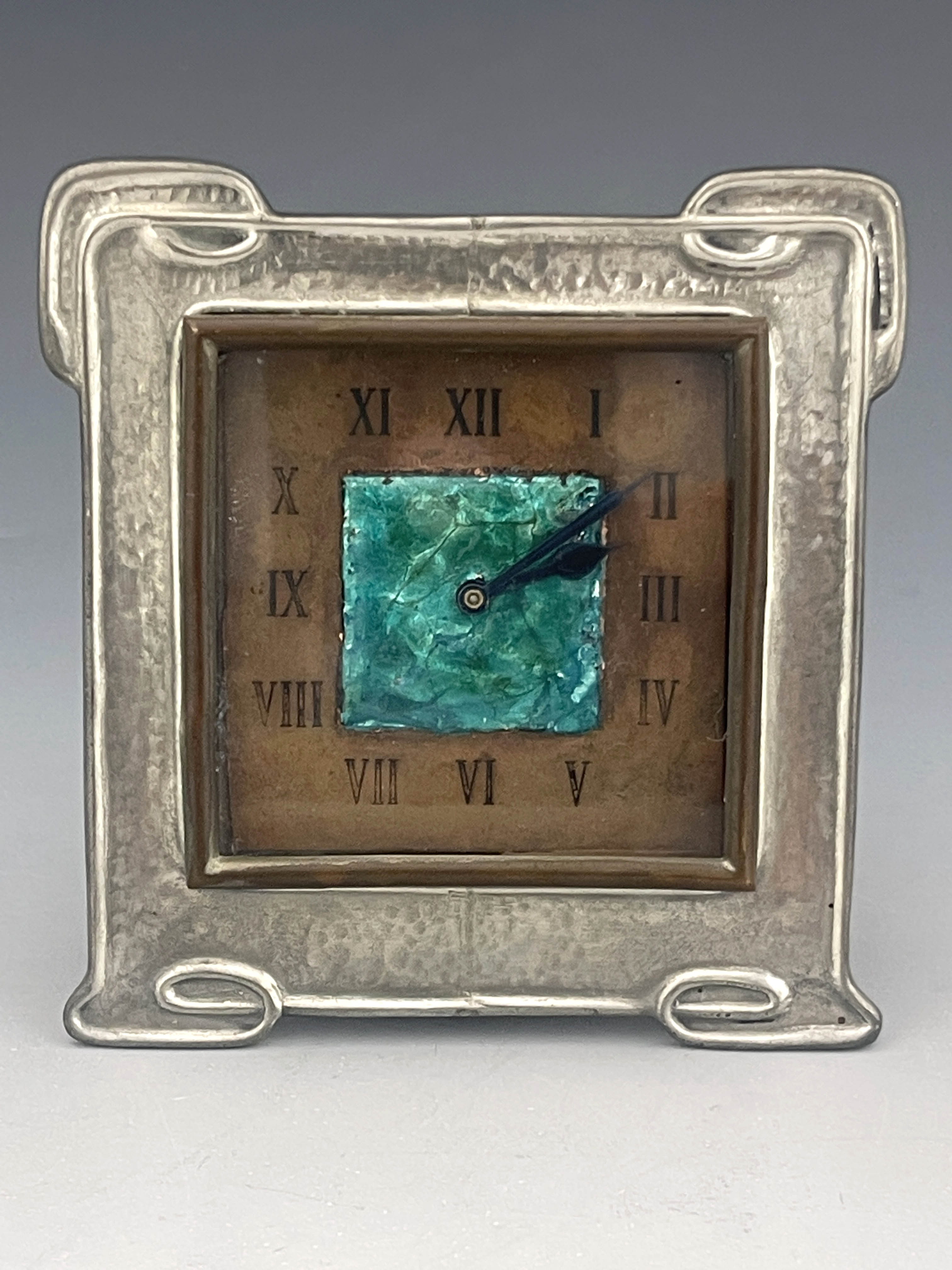 Liberty and Co., an Arts and Crafts Tudric pewter and enamelled clock