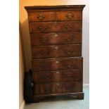 A George II walnut chest on chest, circa 1730, plain cornice, feather banded front with two short