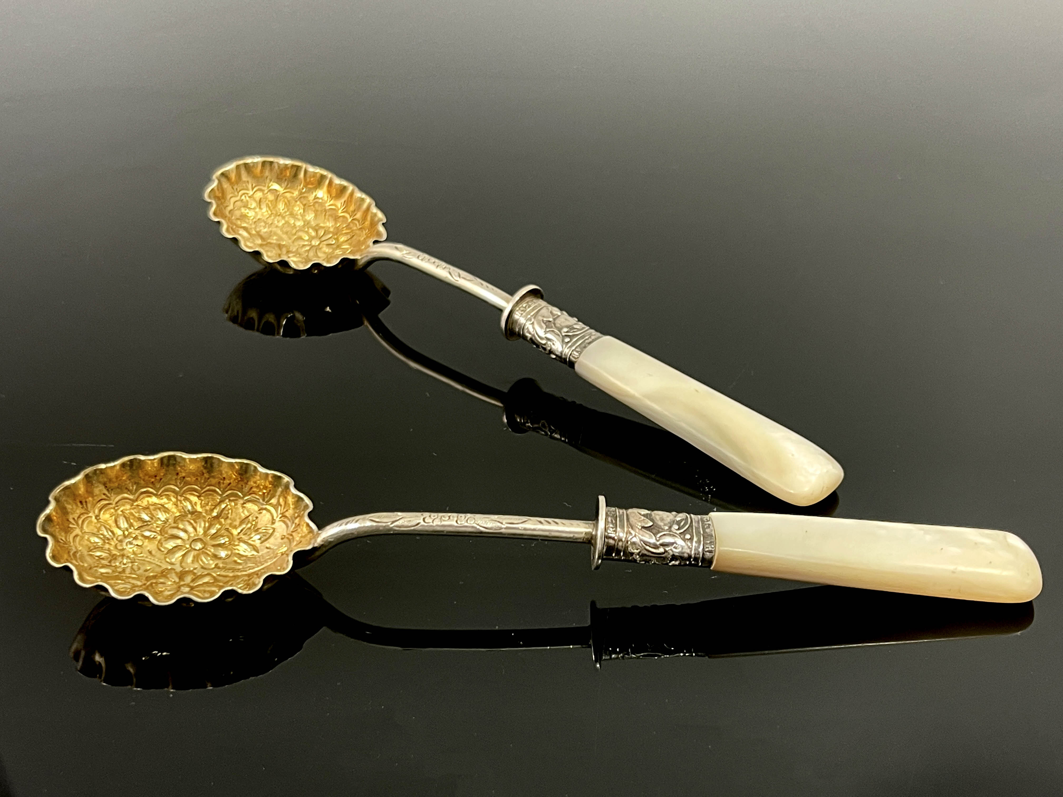 A pair of Victorian silver gilt and mother of pearl fruit spoons, Lee and Wigfull, Sheffield 1897