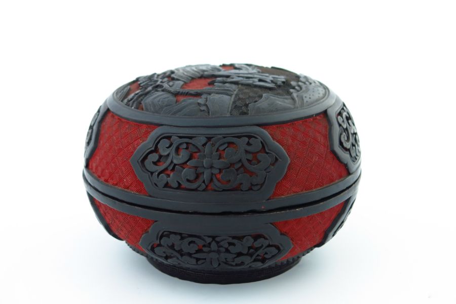 A Chinese red and black lacquer circular covered vessel, carved in high relief with two figures in a - Image 3 of 5