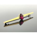 A 9 carat gold and red gem set bar brooch