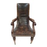 A Regency mahogany library armchair, circa 1820, tan leather studded upholstery and scroll arms,