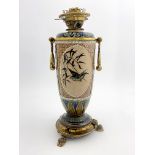 Florence Barlow for Doulton Lambeth, a stoneware oil lamp, 1883, footed ovoid form, decorated with