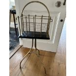 A 19th Century magazine rack, brass loop and handle and bars, tripod base
