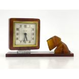A Bayard Art Deco amber bakelite figural desk clock, circa 1930, modelled with a Highland Terrier on