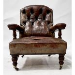 A Victorian mahogany library armchair, circa 1870, worn red leather button back upholstery,