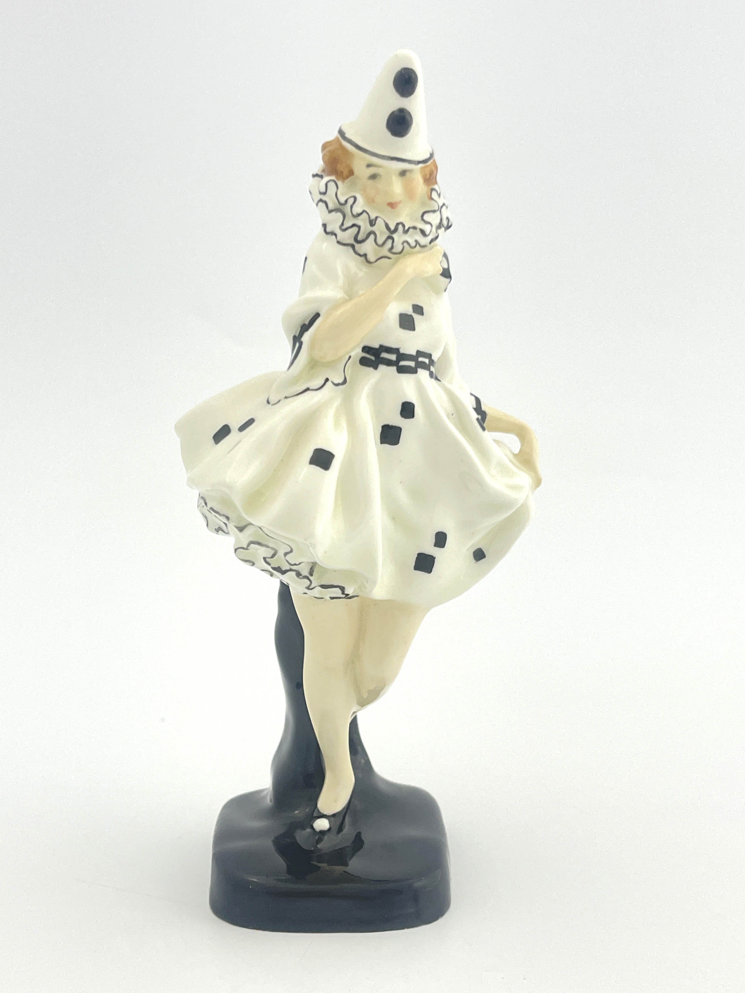 Leslie Harradine for Royal Doulton, a figure, Pierette, HN644, circa 1924, modelled as a clown in