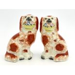 A pair of mid 19th Century Staffordshire chimney spaniels, brown and white coats, dotted
