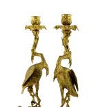 A pair of George IV gilt bronze ormolu figural candlesticks