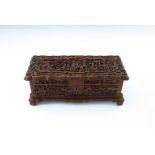 A late 19th Century Cantonese wooden table casket, carved throughout with figures and pagodas in