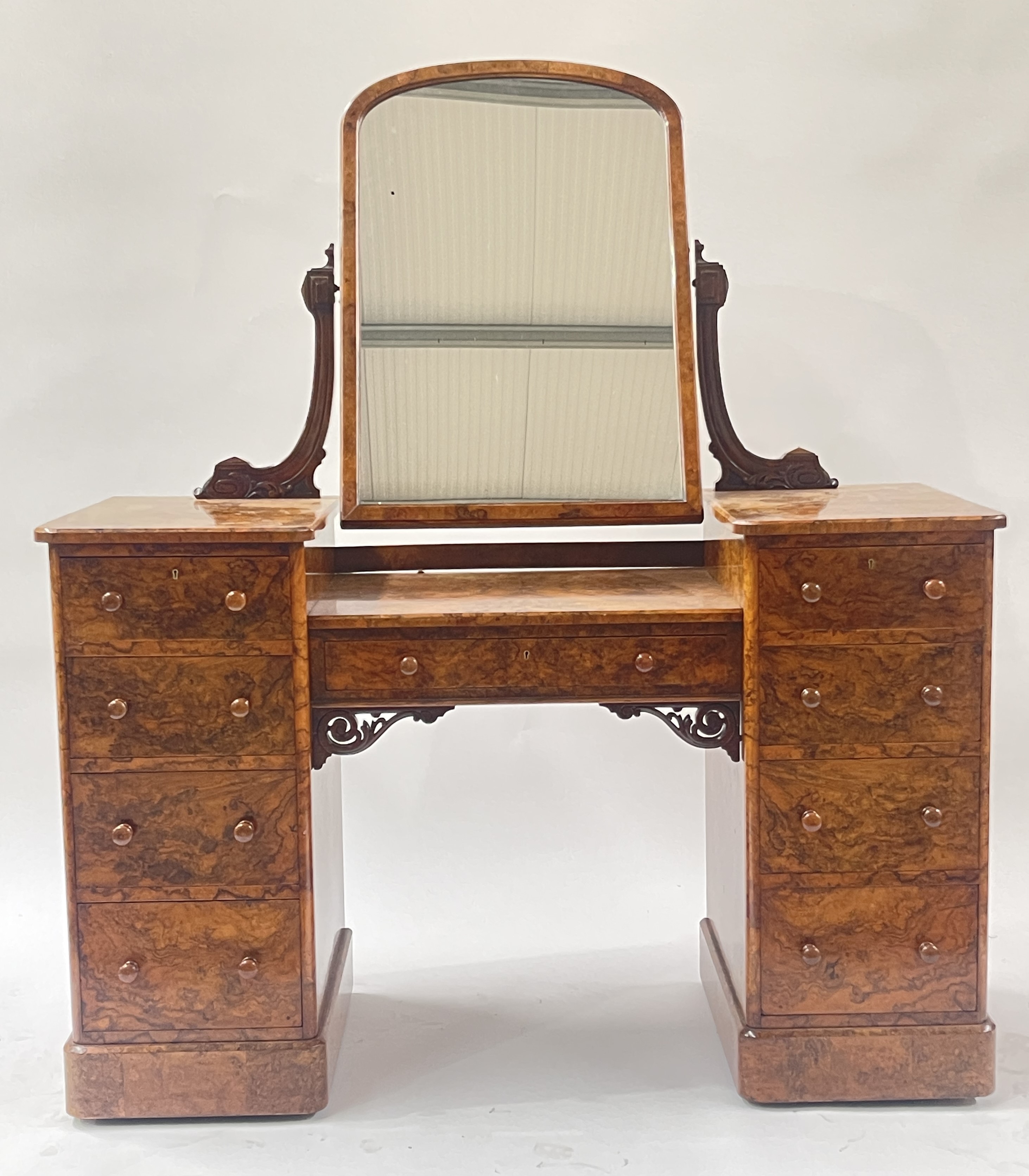 Heal & Son, London, a Victorian burr walnut dressing table, circa 1860, arched top swing mirror,