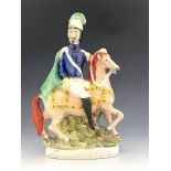 A 19th Century Staffordshire flatback figure group, Louis Napoleon on horseback, wearing a blue