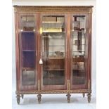 A mahogany vitrine of Louis XVI design, gilt metal and edging throughout, egg and dart cornice,