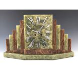 An Art Deco onyx mantel clock, chrome numeral clockface flanked by stepped brown and green onyx