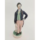 A 19th Century Staffordshire pottery model of Sir Robert Peel, modelled standing wearing a blue gilt