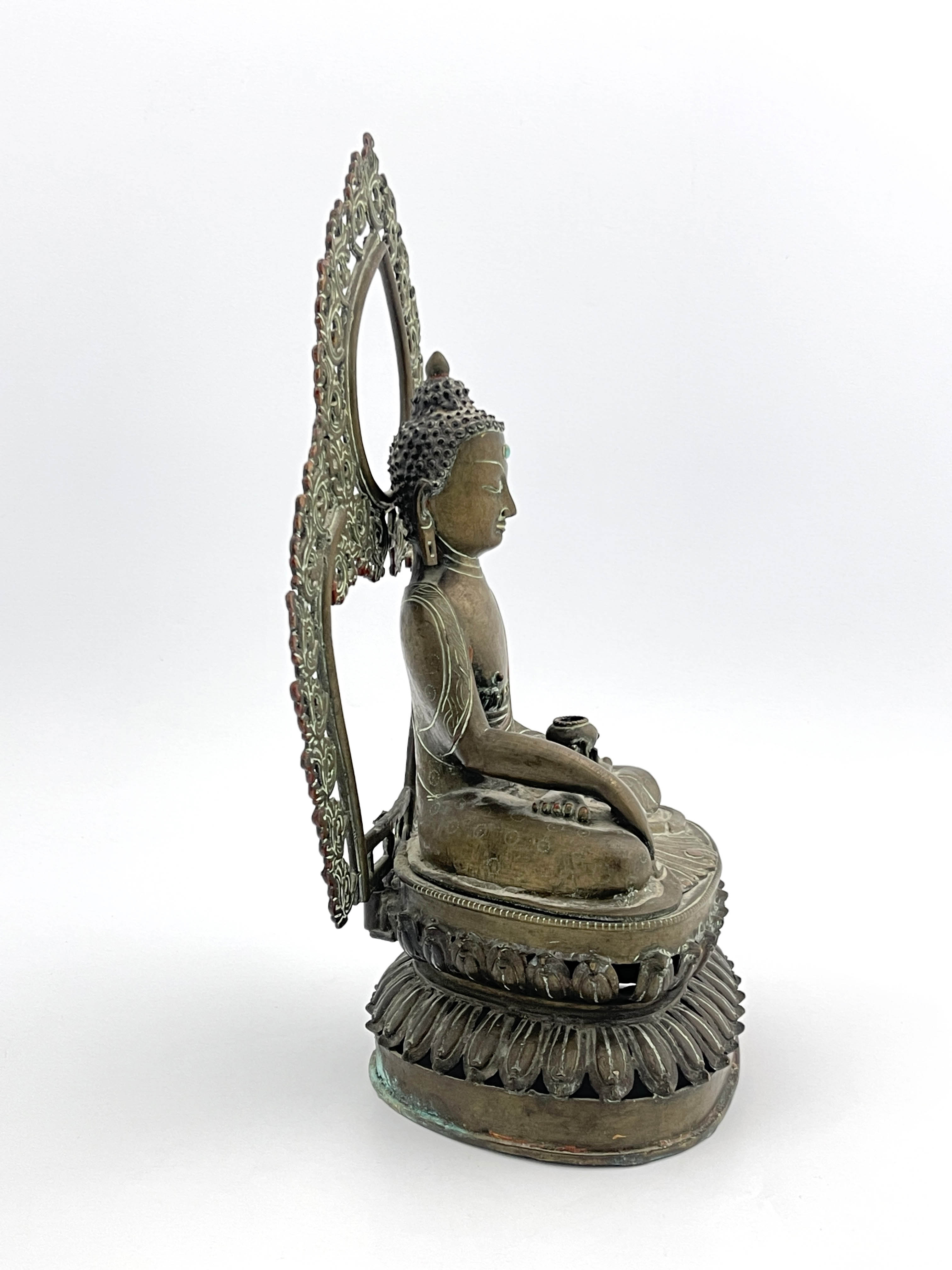 A Nepalese bronze figure of Guanyin, 19th Century, seated cross legged in front of an openwork, - Image 4 of 6