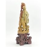 A Chinese soapstone carving, in the form of a figure of a fisherman on a stand, 43cm high