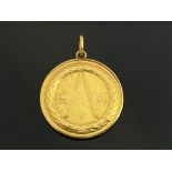 An 18ct gold Belgian golf medal, recto with laurel border and sun rising over fairway with two