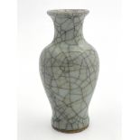 A Chinese monochrome baluster vase, olive crackle glaze, 17cm high