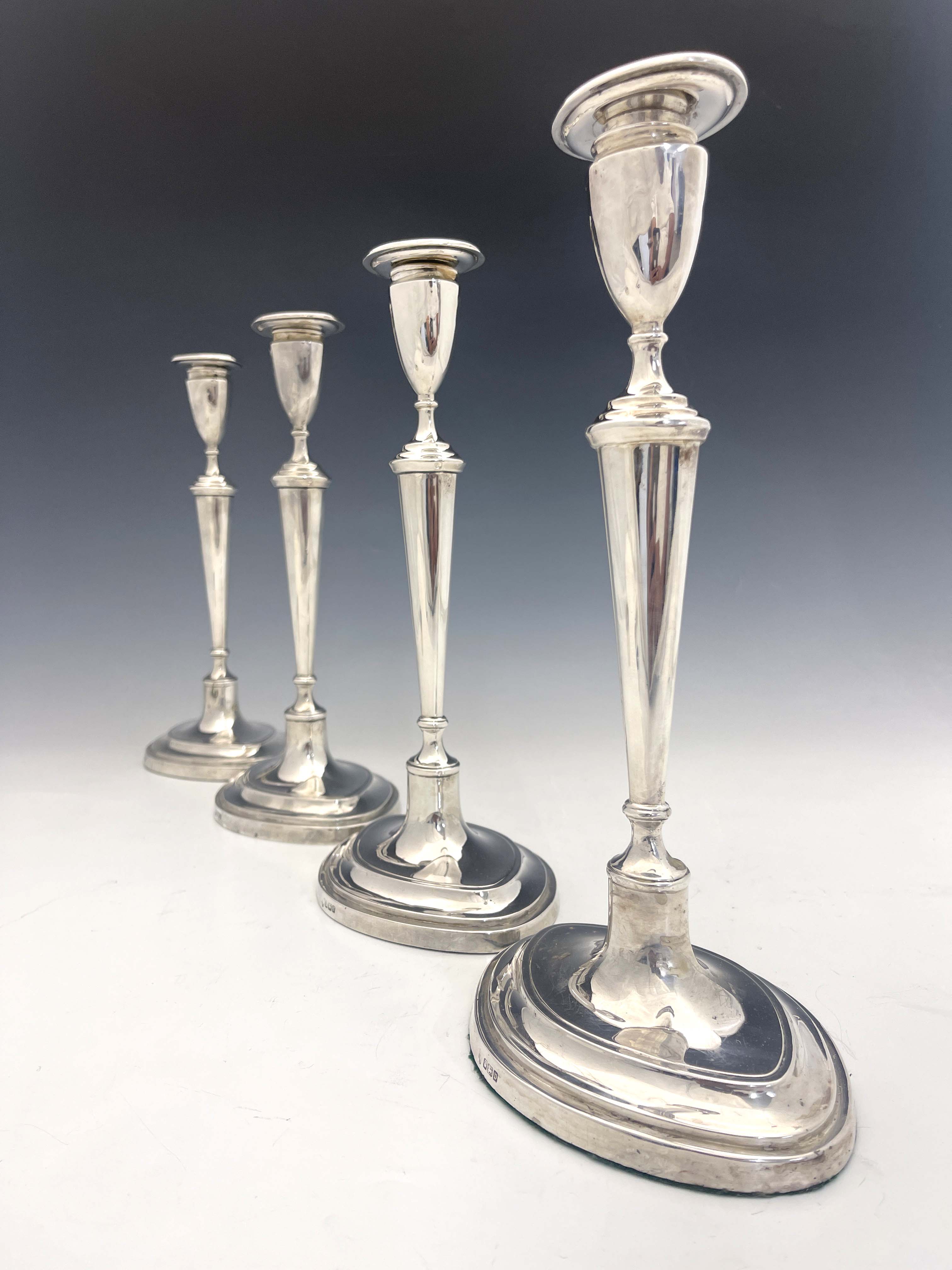 A set of four George V silver candlesticks, Hawksworth, Eyre and Co., Sheffield 1913