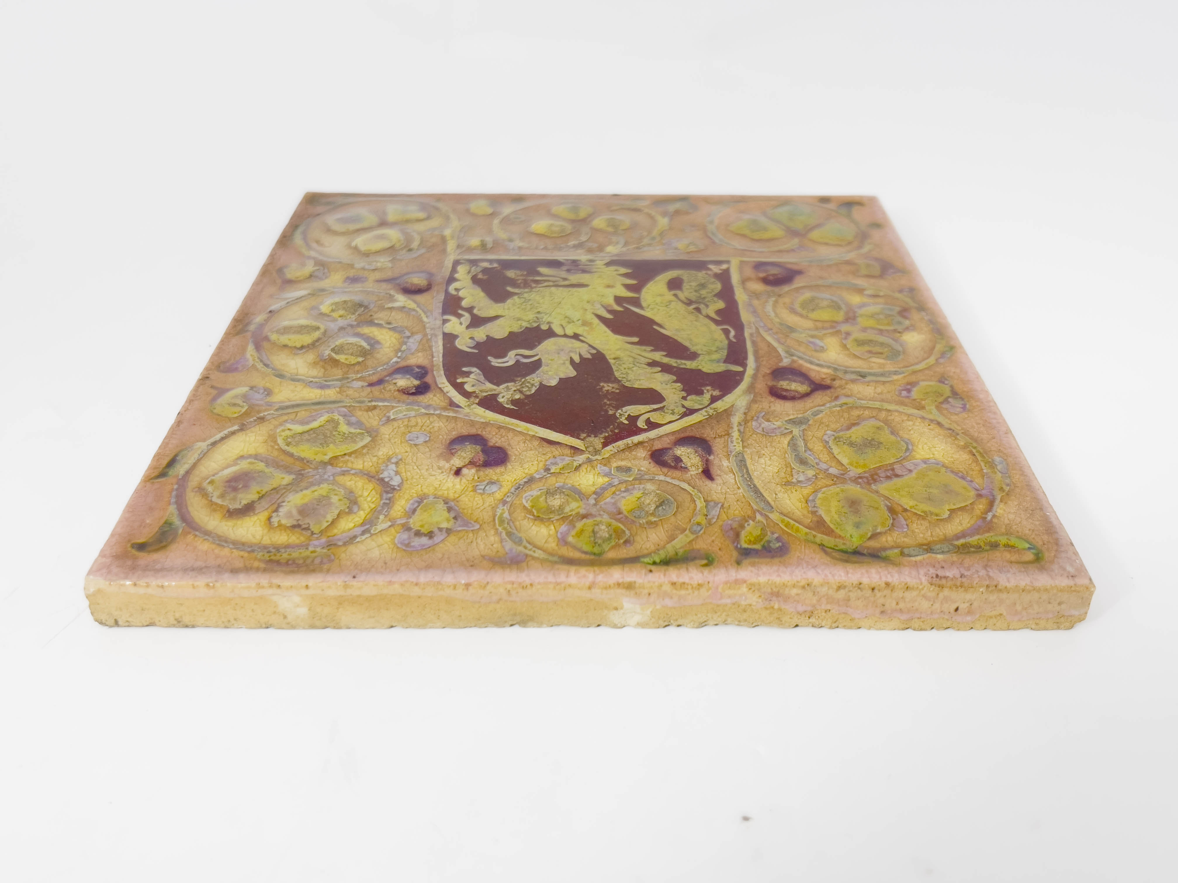 Pilkington, a Royal Lancastrian relief moulded heraldic lustre tile, painted with a red shield - Image 2 of 3