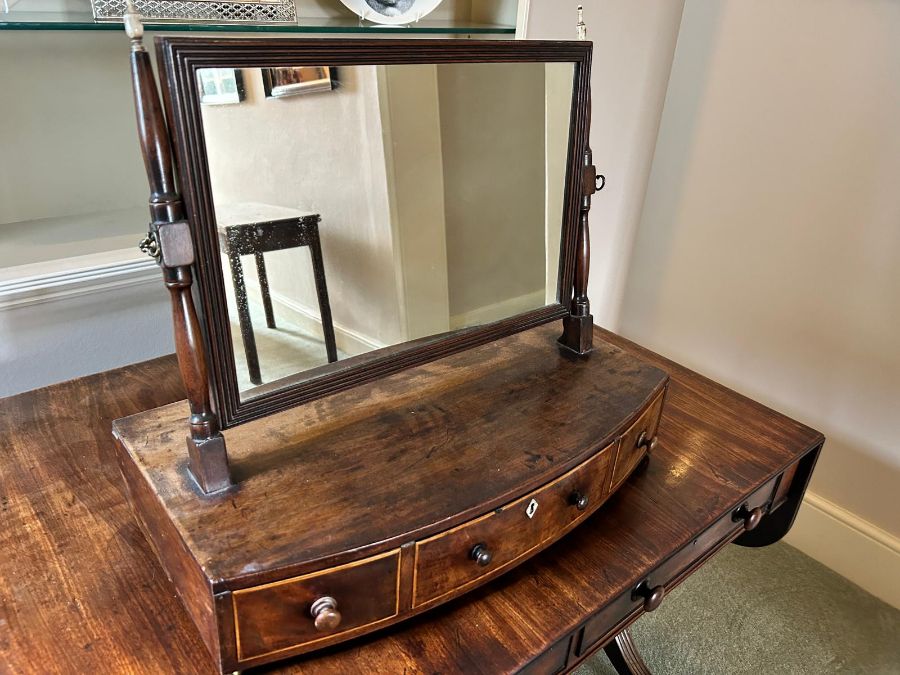 A Regency mahogany toilet mirror, circa 1820, rectangular plate, ivory finials, gilt brass