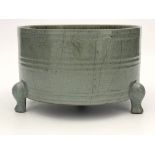 A Chinese Sung type jardiniere, 19th Century or later, of cylinder form on triple feet, olive