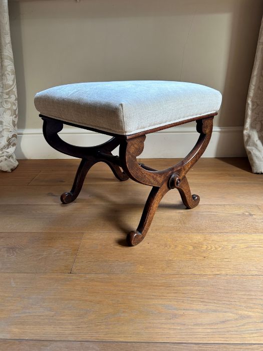 A William IV rosewood X framed stool, circa 1835, upholstered seat, the end supports united by a