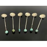 A set of six Arts and Crafts turquoise and white metal coffee spoons