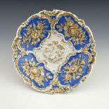 An early 20th century Meissen Leuteritz rococo relief moulded plate, circular dished form, decorated