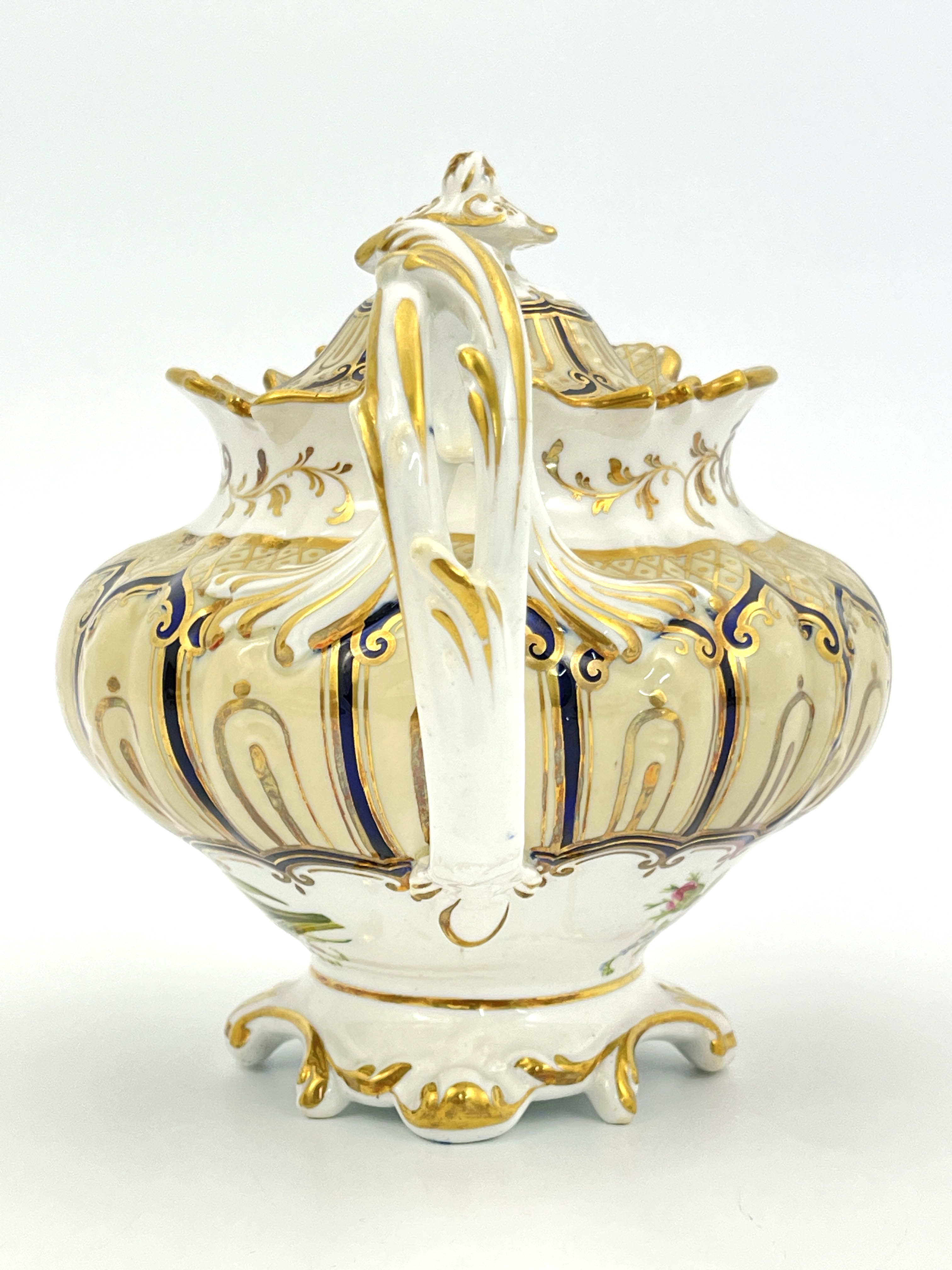 An English bone china teapot and cover, circa 1840, of Rococo design with gilt and blue ogee cover - Image 4 of 8