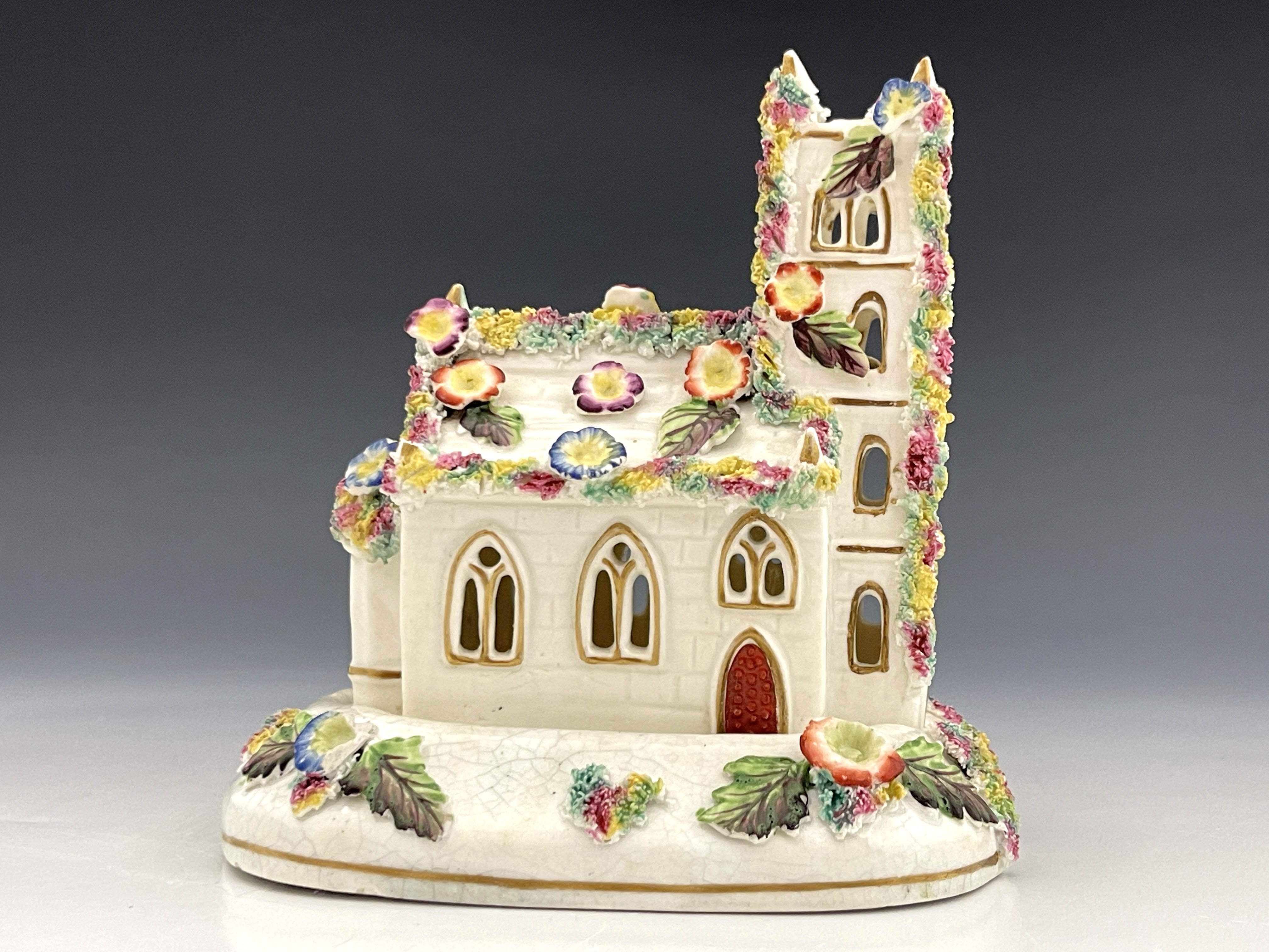 A 19th Century pastille burner on a separate stand, modelled as a Gothic church with tower, florally