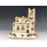 A 19th Century pastille burner on a separate stand, modelled as a Gothic church with tower, florally