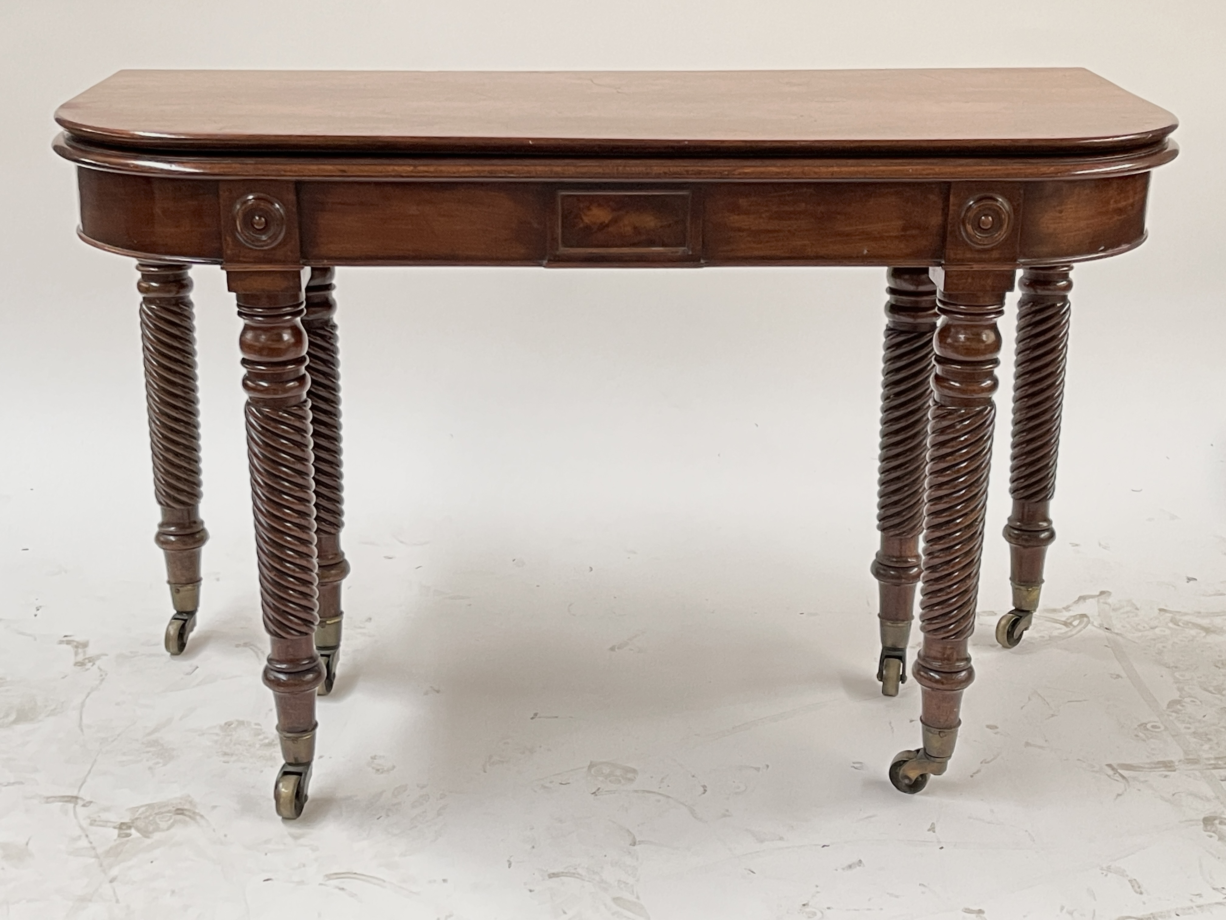 A George III mahogany metamorphic D-end dining table, circa 1810, with three additional leaves,