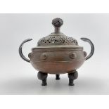A 19th Century Chinese bronze censer and cover, scrollwork reticulated domed cover with ball finial,
