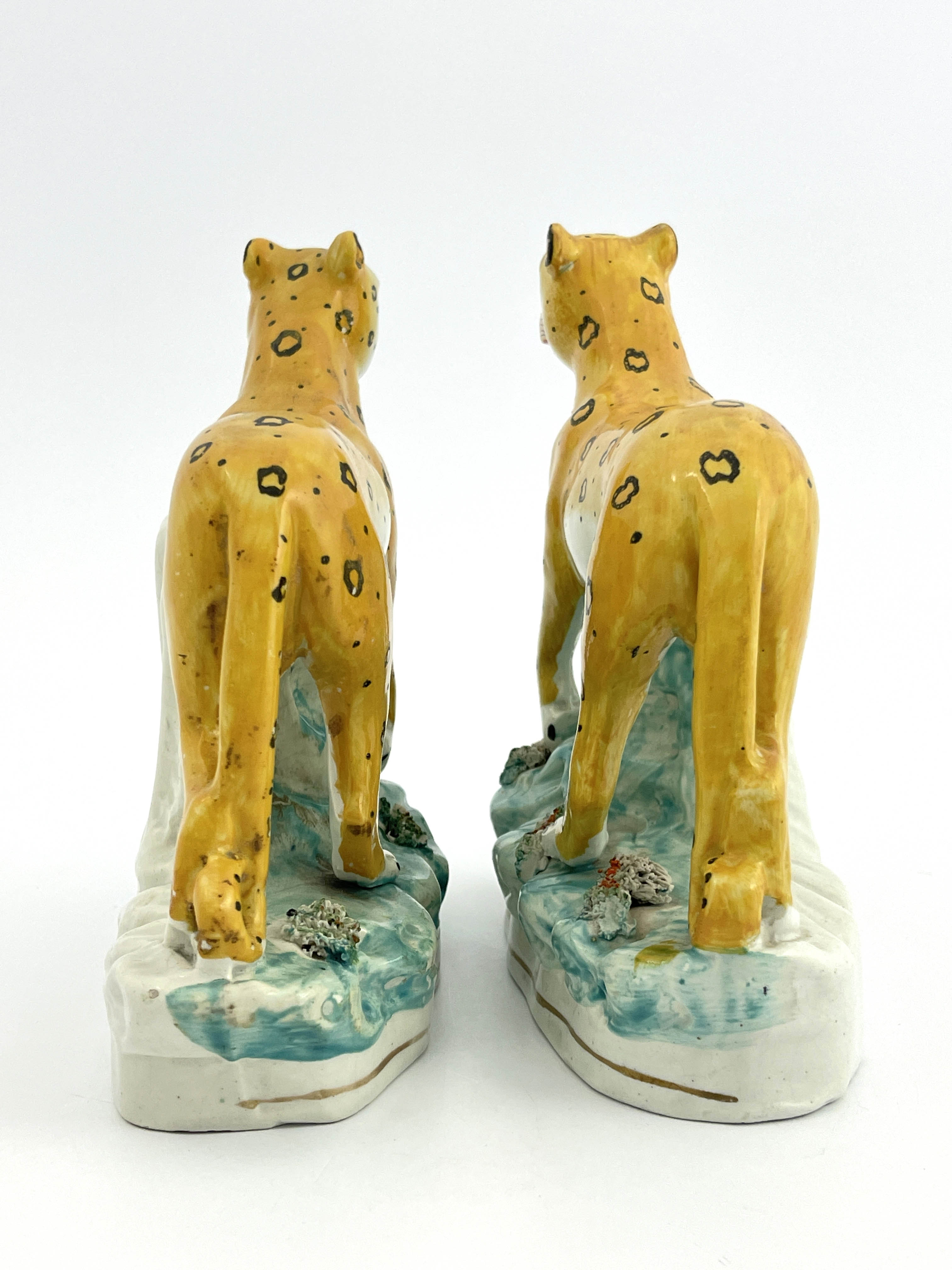 A rare pair of 19th Century Staffordshire pottery leopards, modelled strolling and decorated in - Image 3 of 7