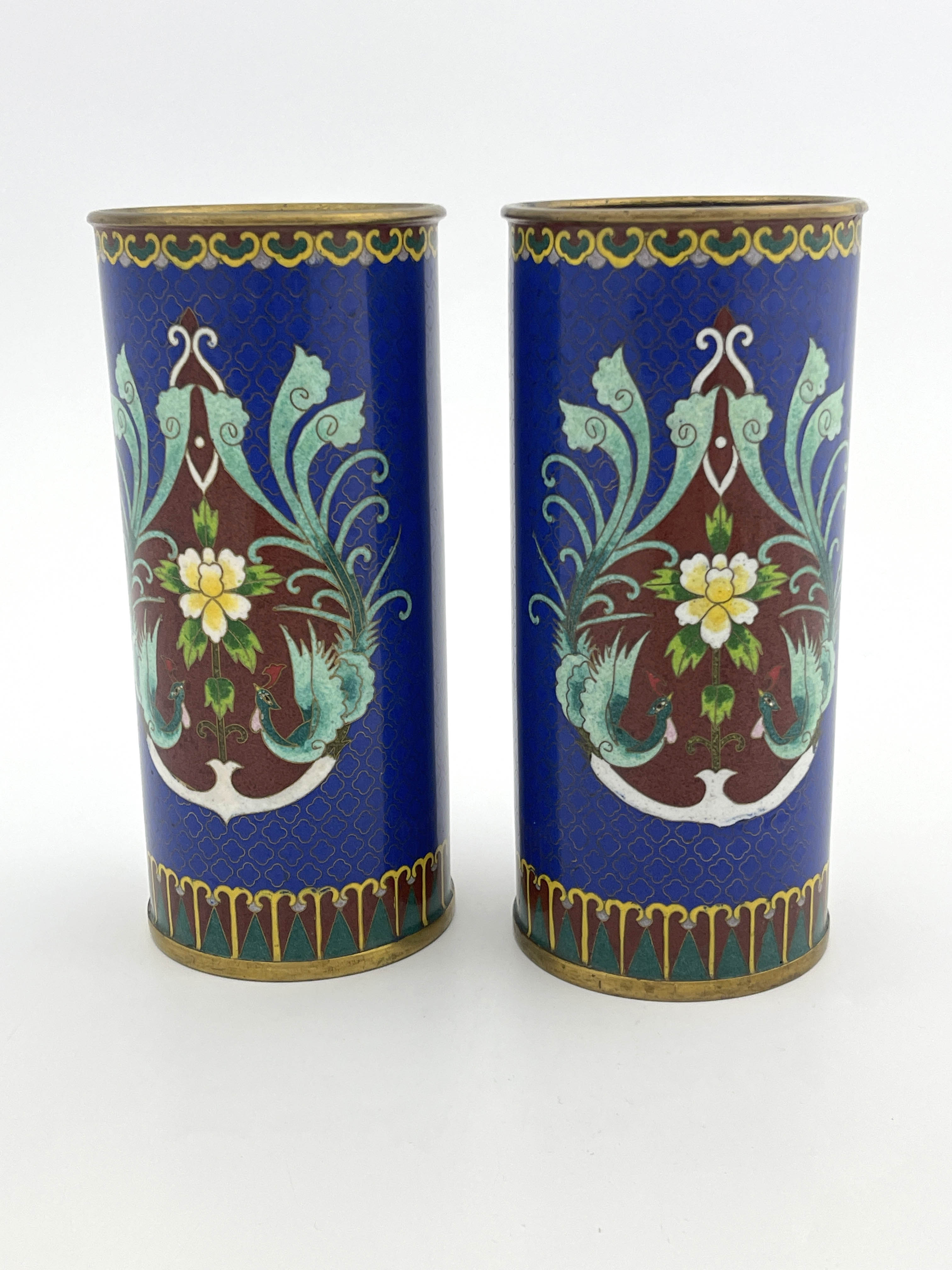 A pair of oriental cloisonne sleeve vases, decorated with stylised exotic birds amongst foliage on a