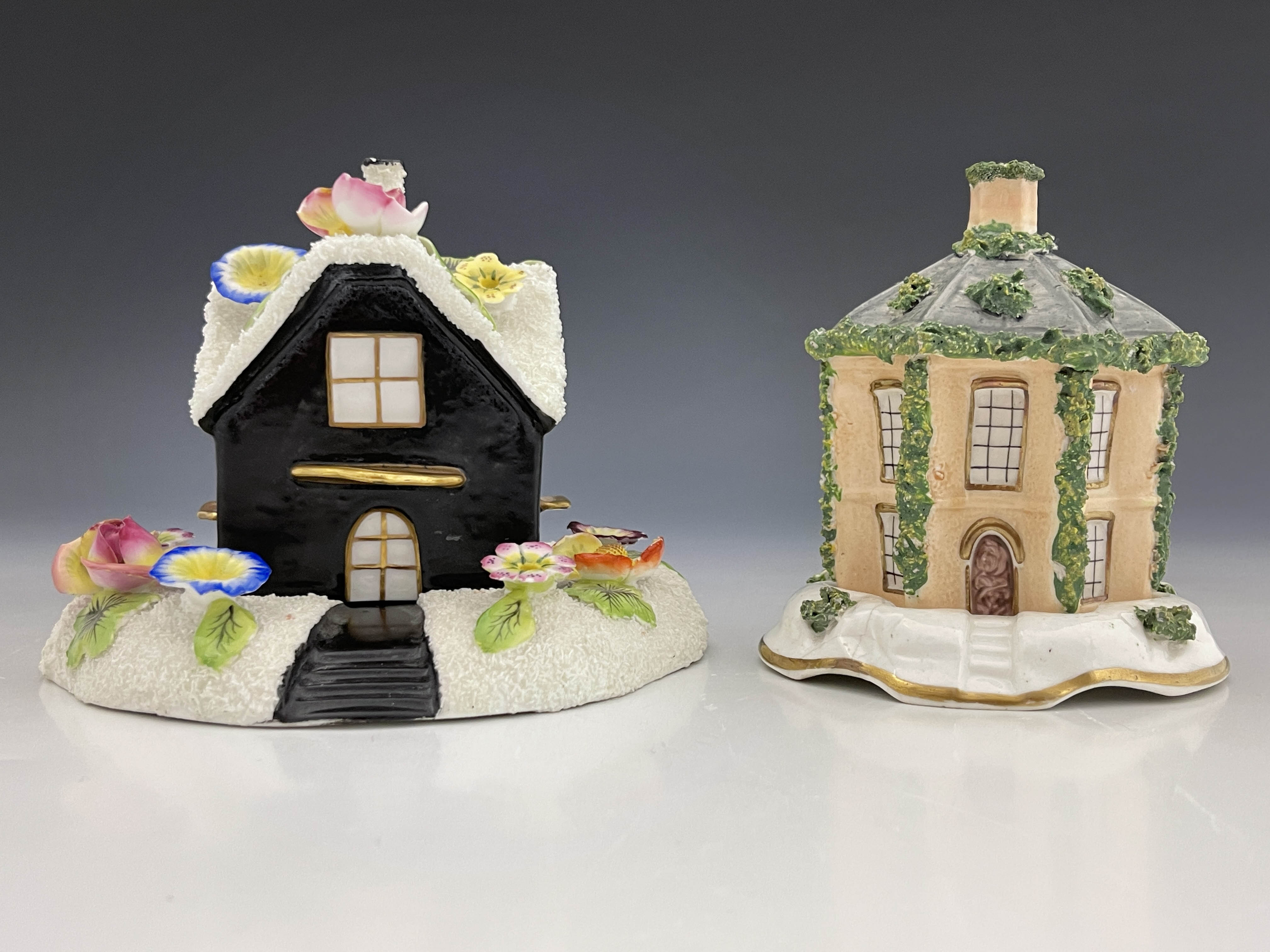 Two 19th Century pastille burners on separate plinths, to include a gabled cottage with gilt front