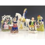 A group of five 19th Century Staffordshire pottery and porcelain figures, to include lovers under an