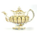 An English bone china teapot and cover, circa 1840, of Rococo design with gilt and blue ogee cover