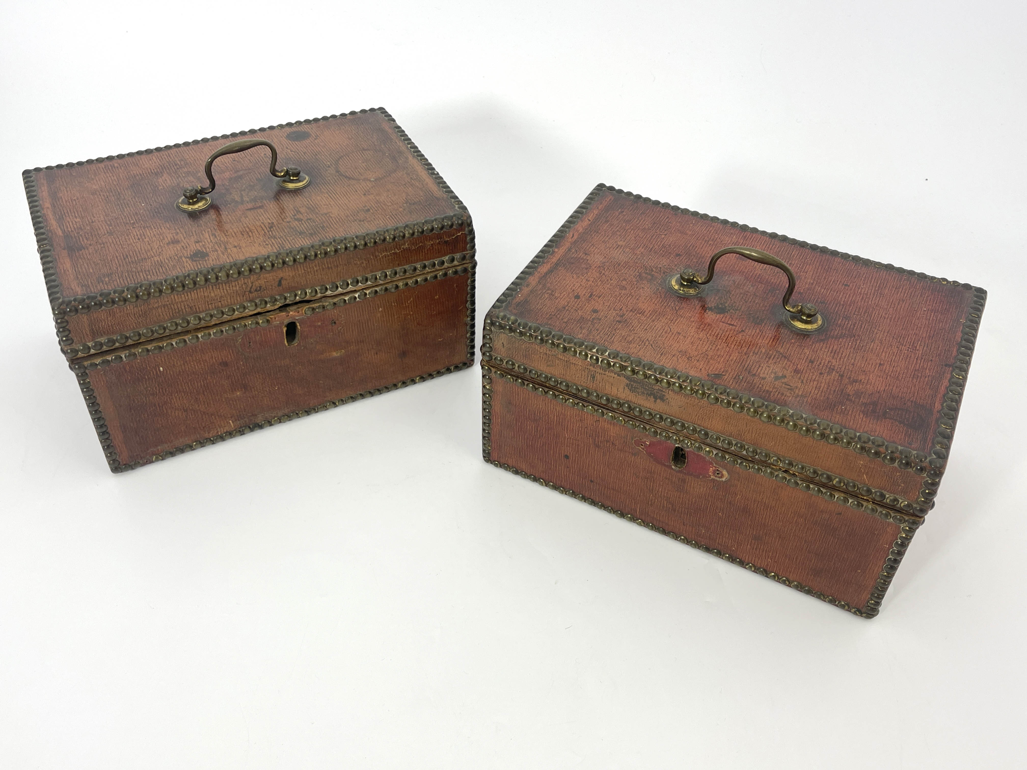 A pair of George III deed boxes, morocco bound with brass studded borders, swing handles to the ring - Image 2 of 4