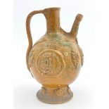 An Islamic stoneware ewer, of ovoid form with handle, sprigged medallions of Islamic script and